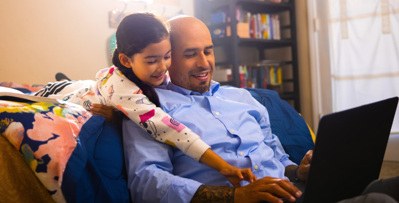 man studying with his young daughter 