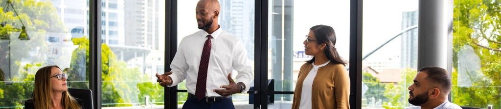 People in office talking and working together around a table