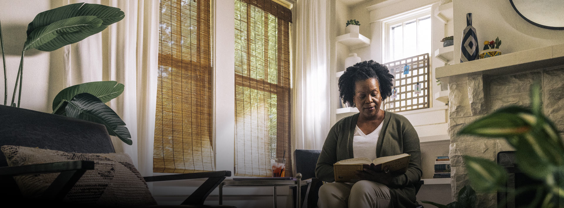 Person reading book in living room