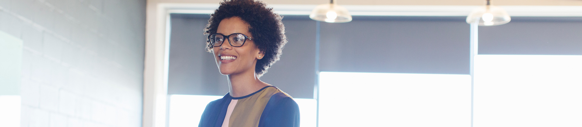 woman with glasses smiling