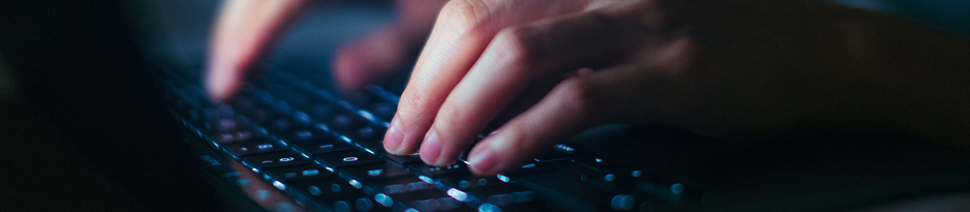 close up view of someone typing on a keyboard