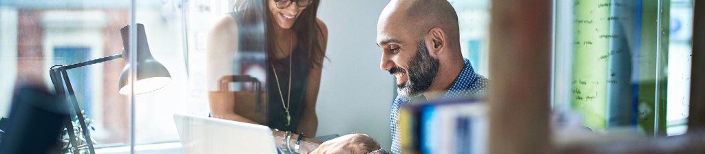 people in office working together on laptop