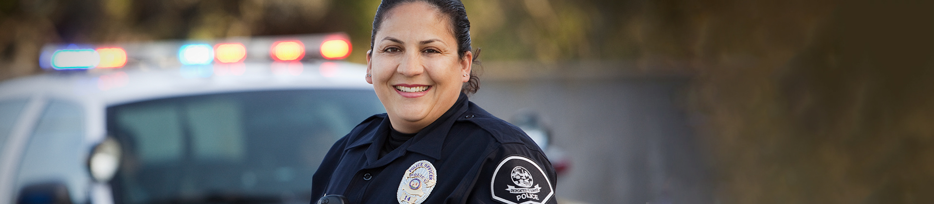 police officer standing in front of a patrol car