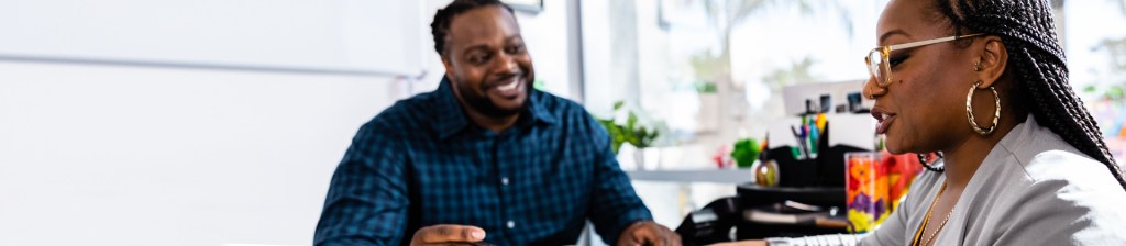 People talking at desk in office