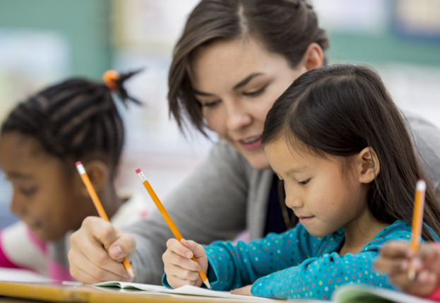 a teacher helps students with work